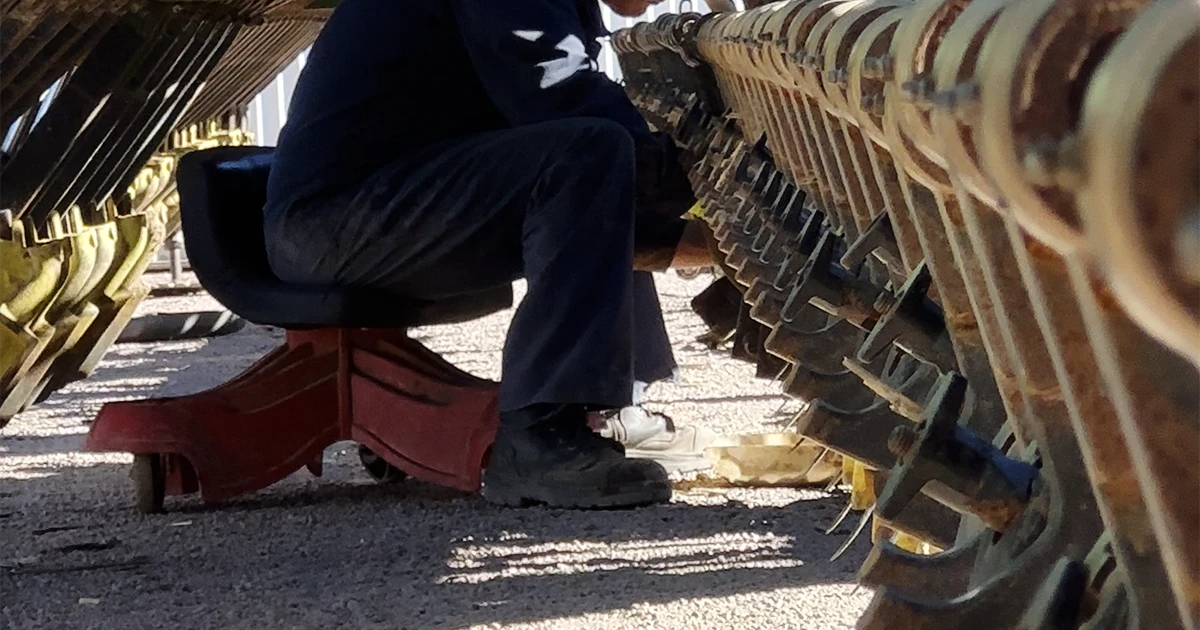farmer working underneath planter